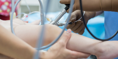 An urologist performing a cystoscopy procedure.